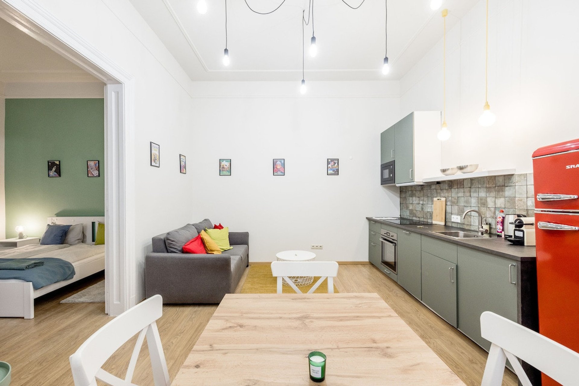 Living room with open-plan kitchen and dining area, main bedroom to the right