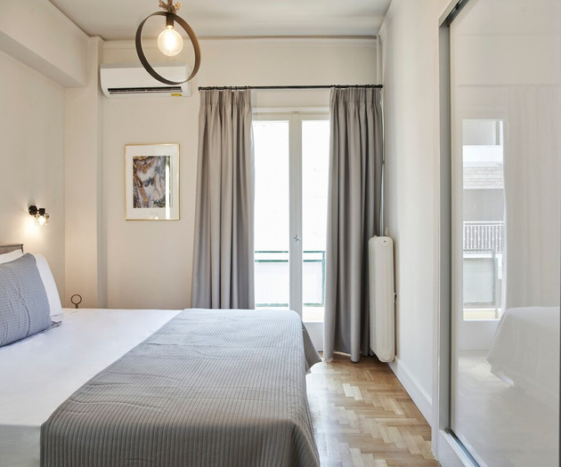 The second bedroom with a king size bed and a balcony