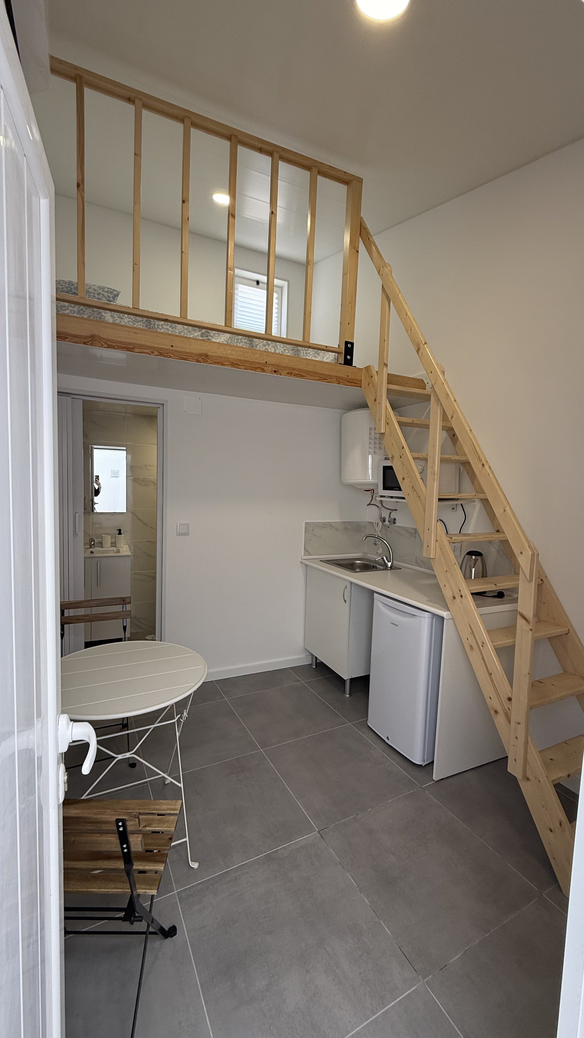 Studio overview with kitchen and stairs