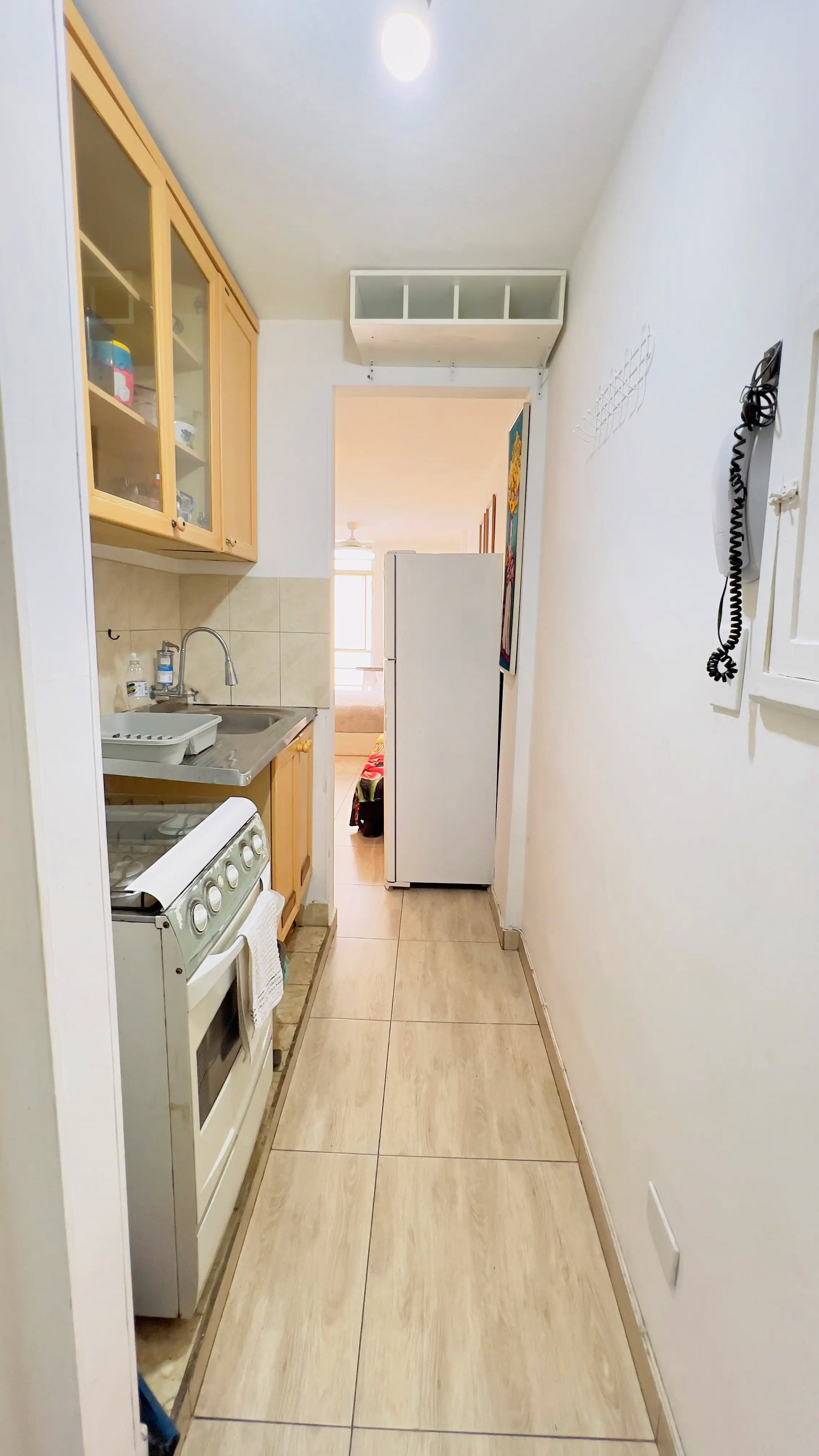 Narrow kitchen with stove refrigerator