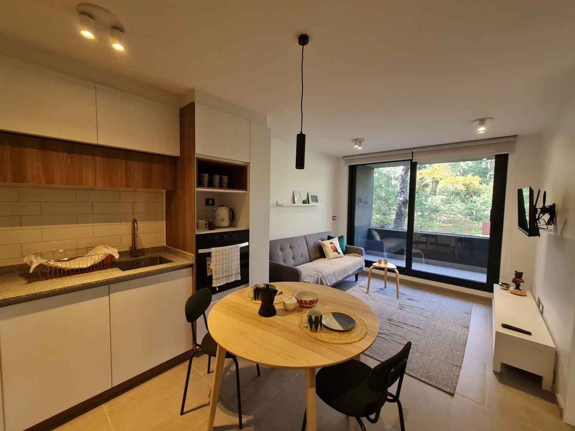 Bright open-concept living space with high-speed WiFi and natural light. Fully equipped kitchen, cozy lounge area, and direct access to a private terrace overlooking the forest — ideal for working remotely or relaxing after a hike.