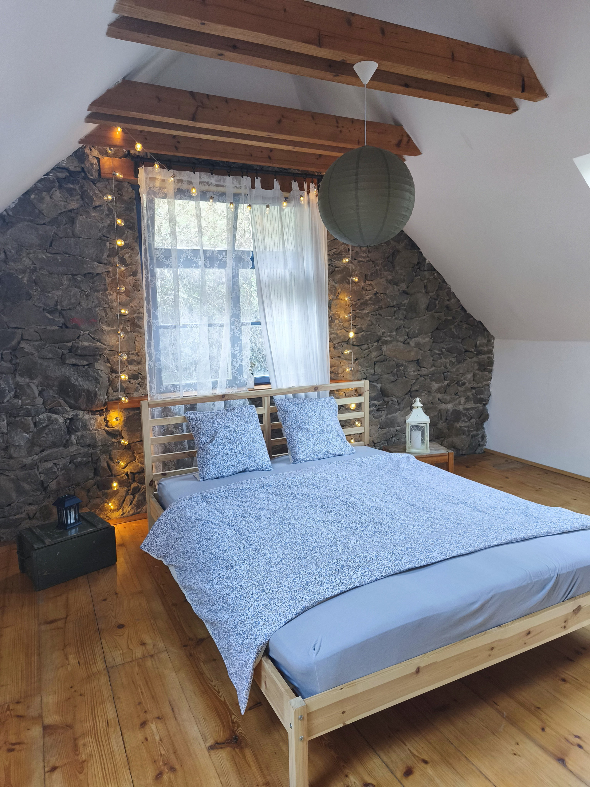 Attic bedroom with stone wall