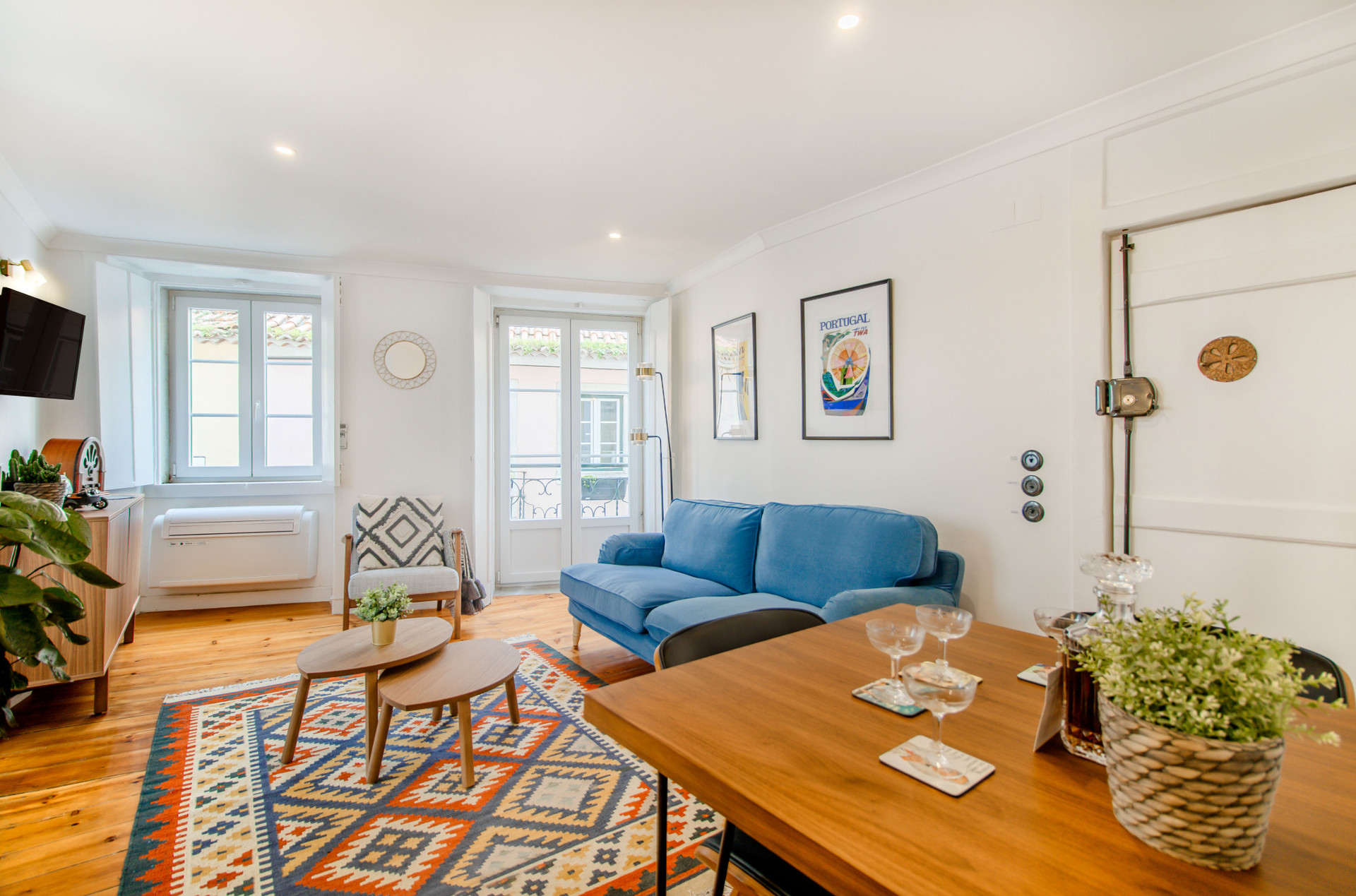 Living Room with Flat-Screen TV, tons of natural light, comfy furniture, air-conditioning and heating, beautiful art and details.