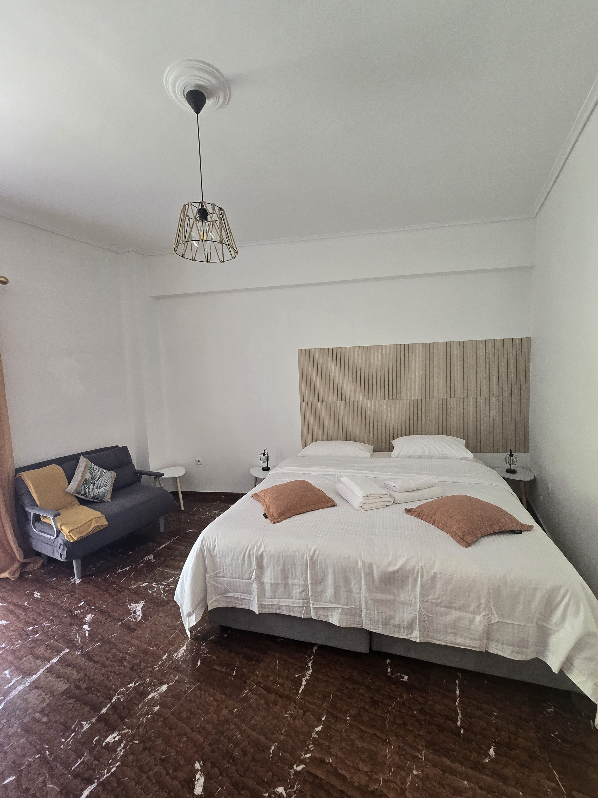 Bedroom with double bed and sofa