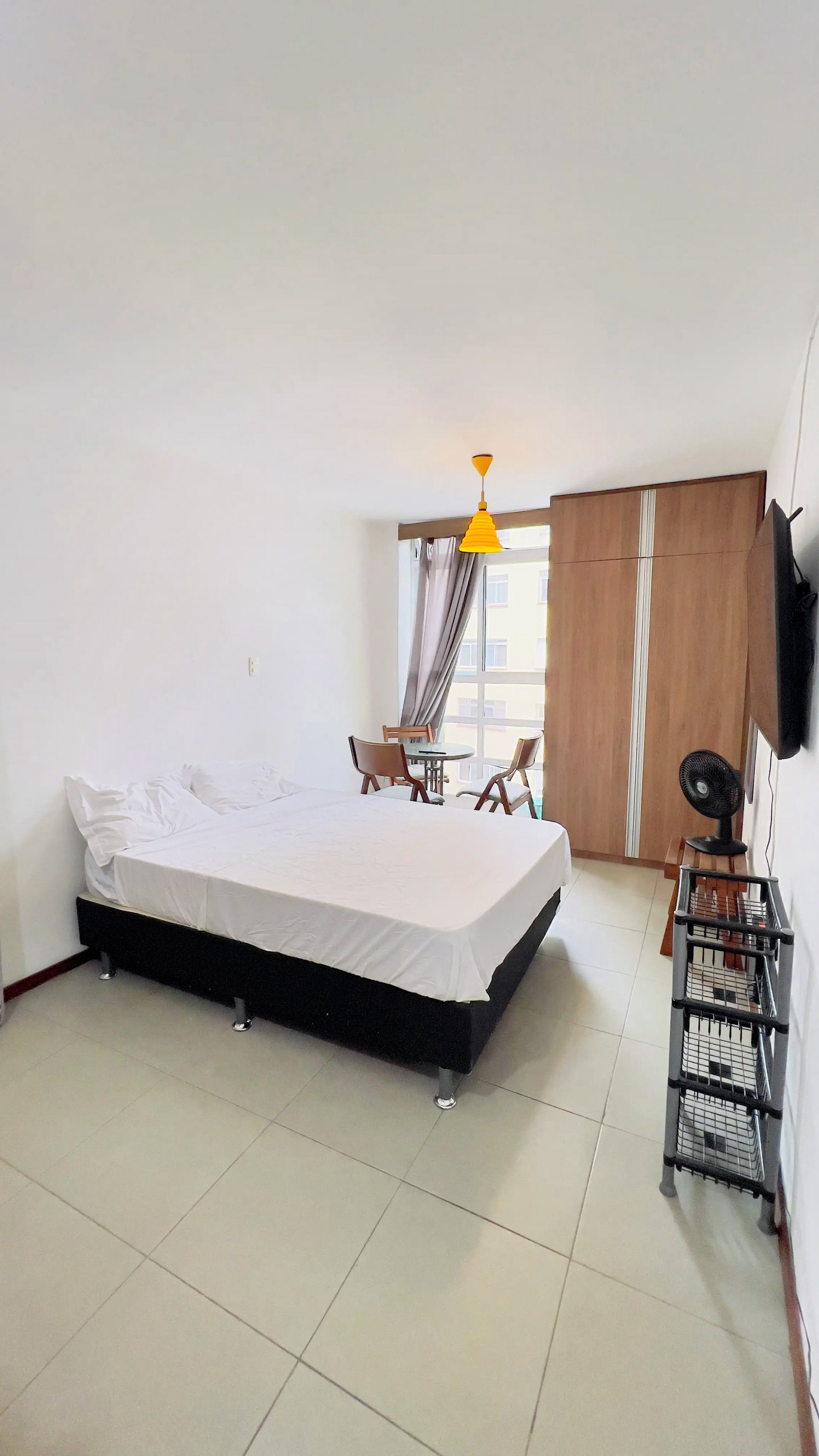 Studio bedroom with wardrobe and TV