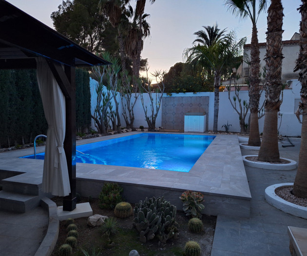 Twilight pool with palm trees