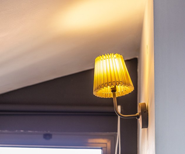 Glowing sconce near window