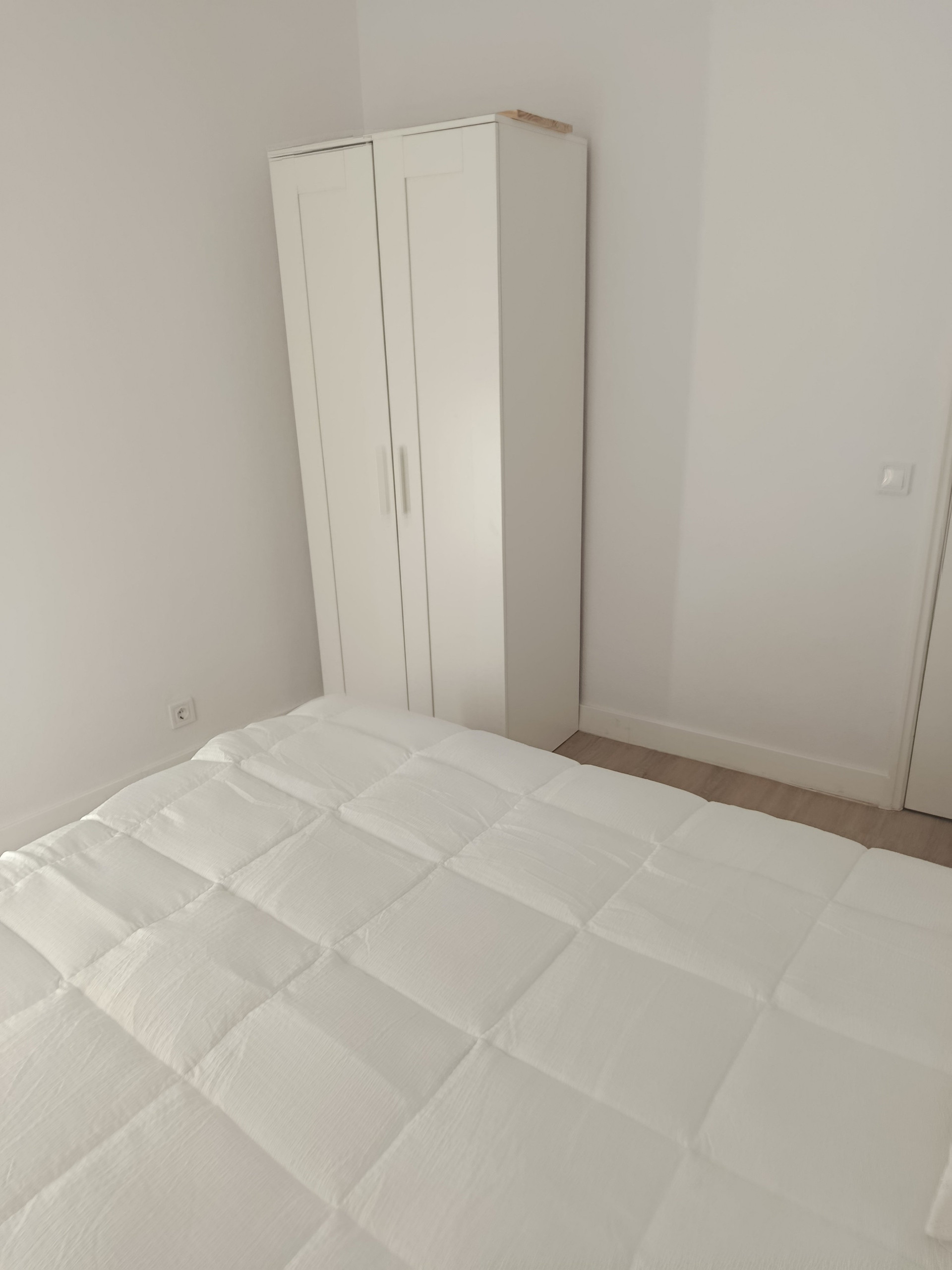 Bedroom with white wardrobe
