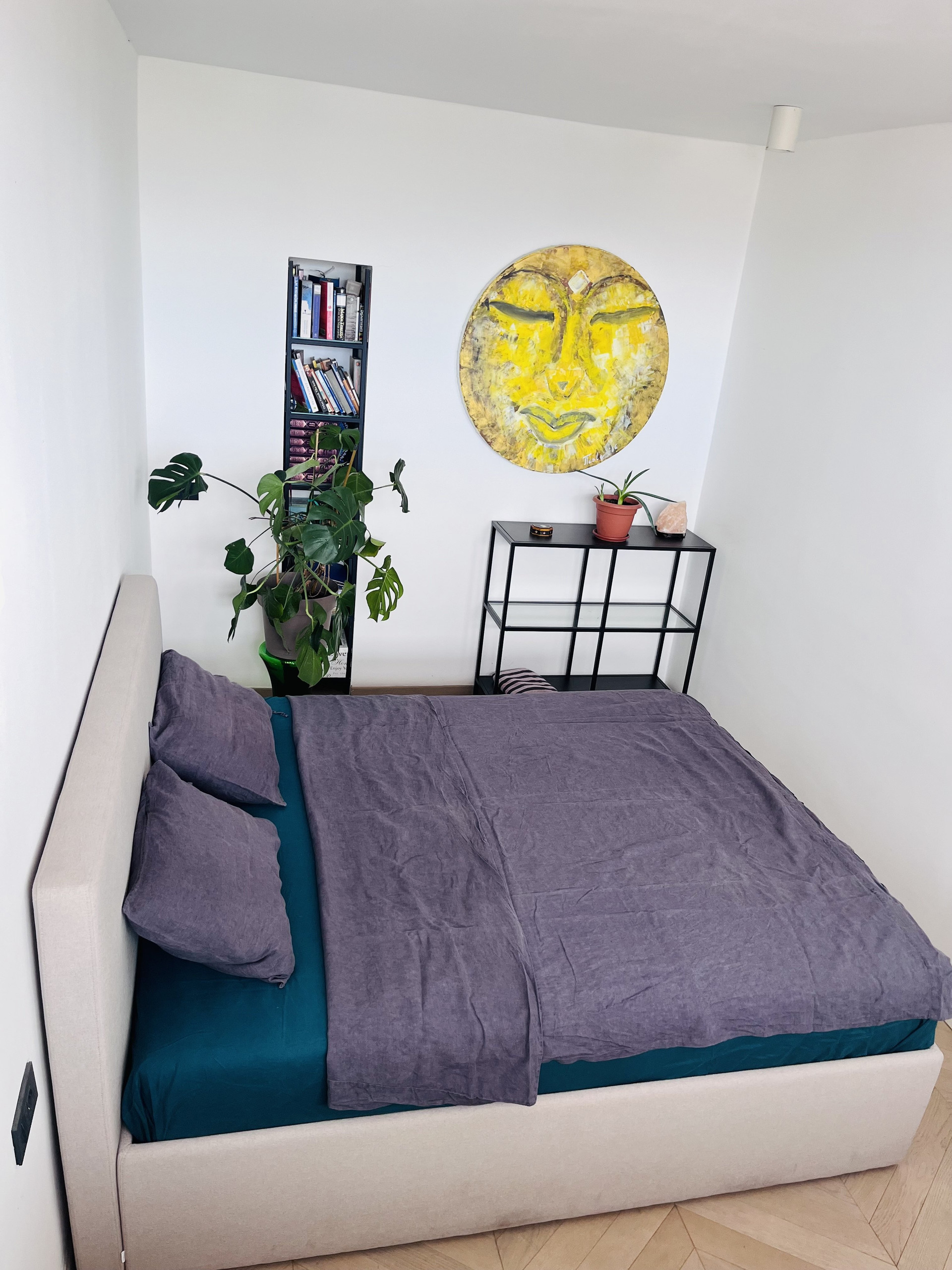 Bedroom with artwork and bookshelf