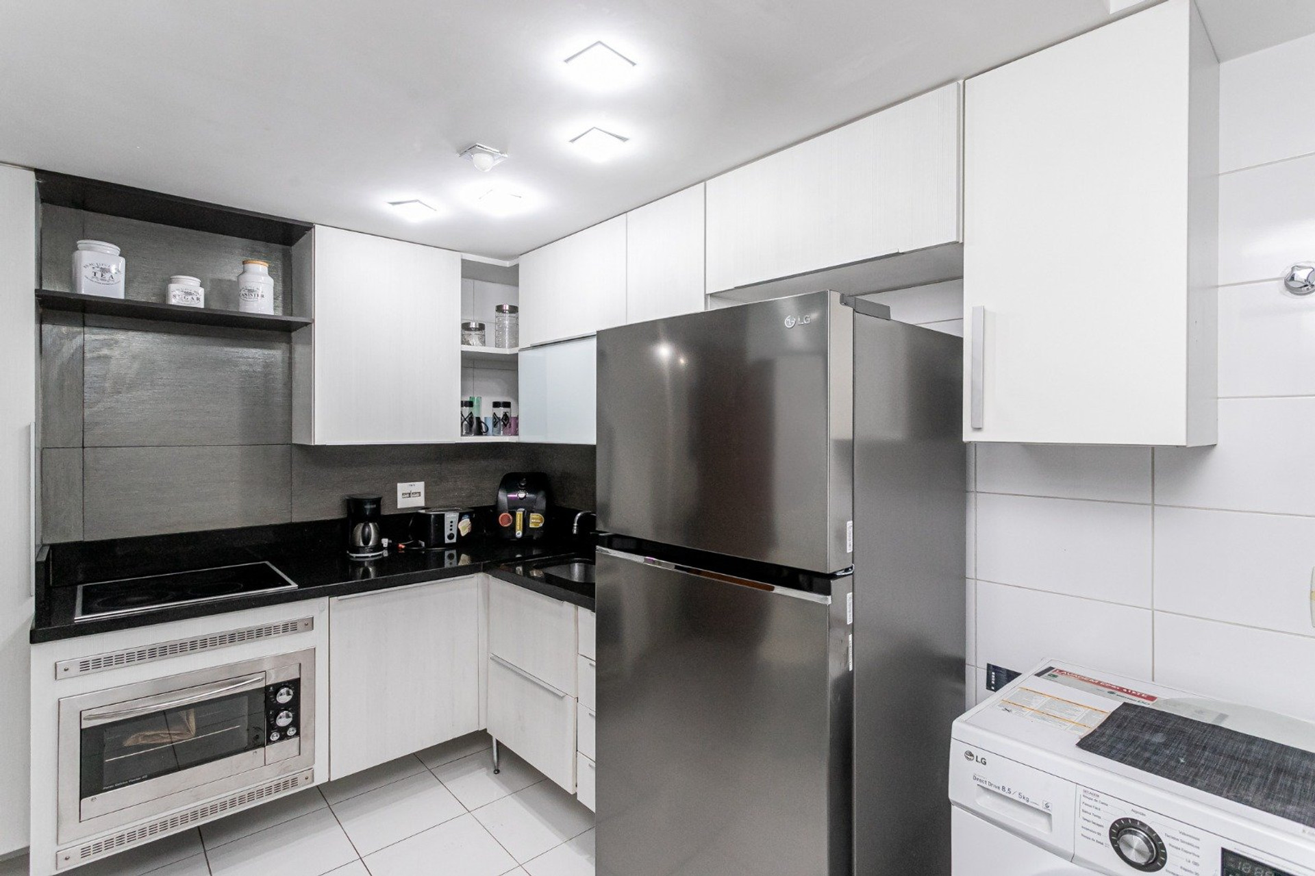 Compact kitchen with stainless fridge