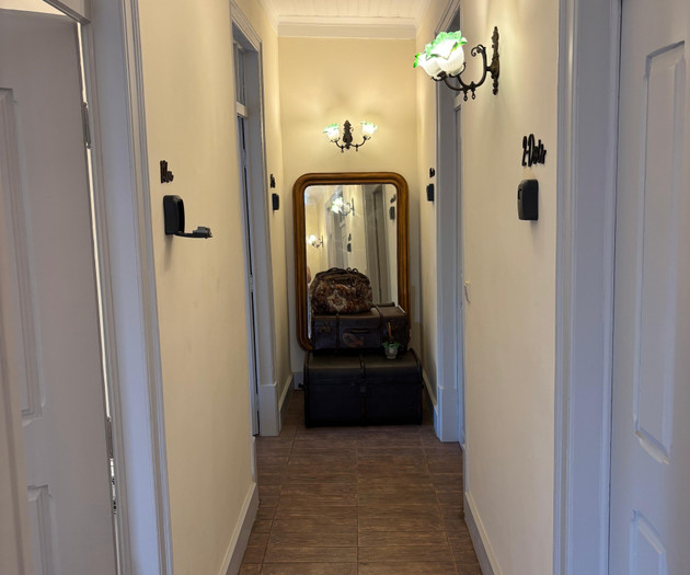 Hallway with mirror and doors