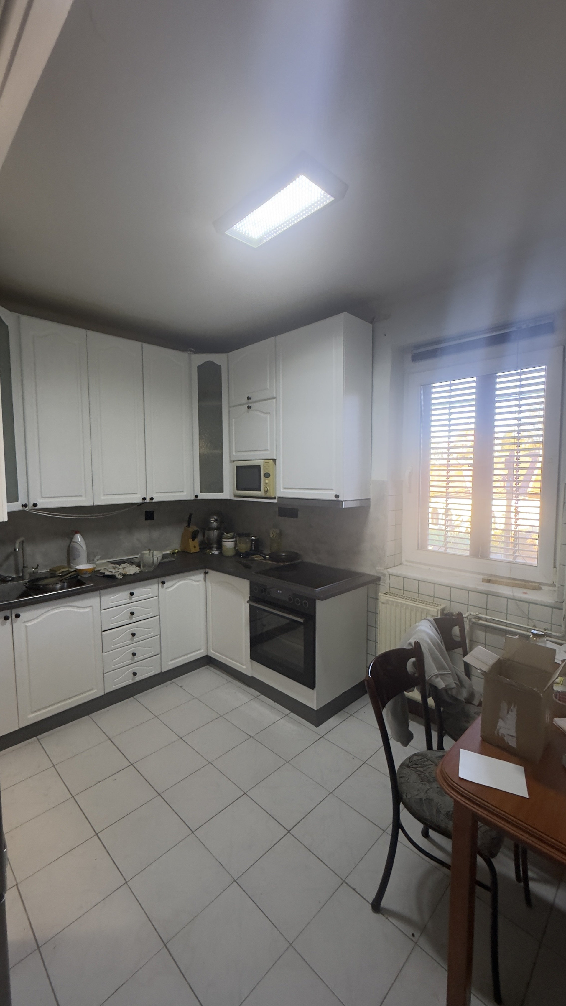 Kitchen with white cabinets and table