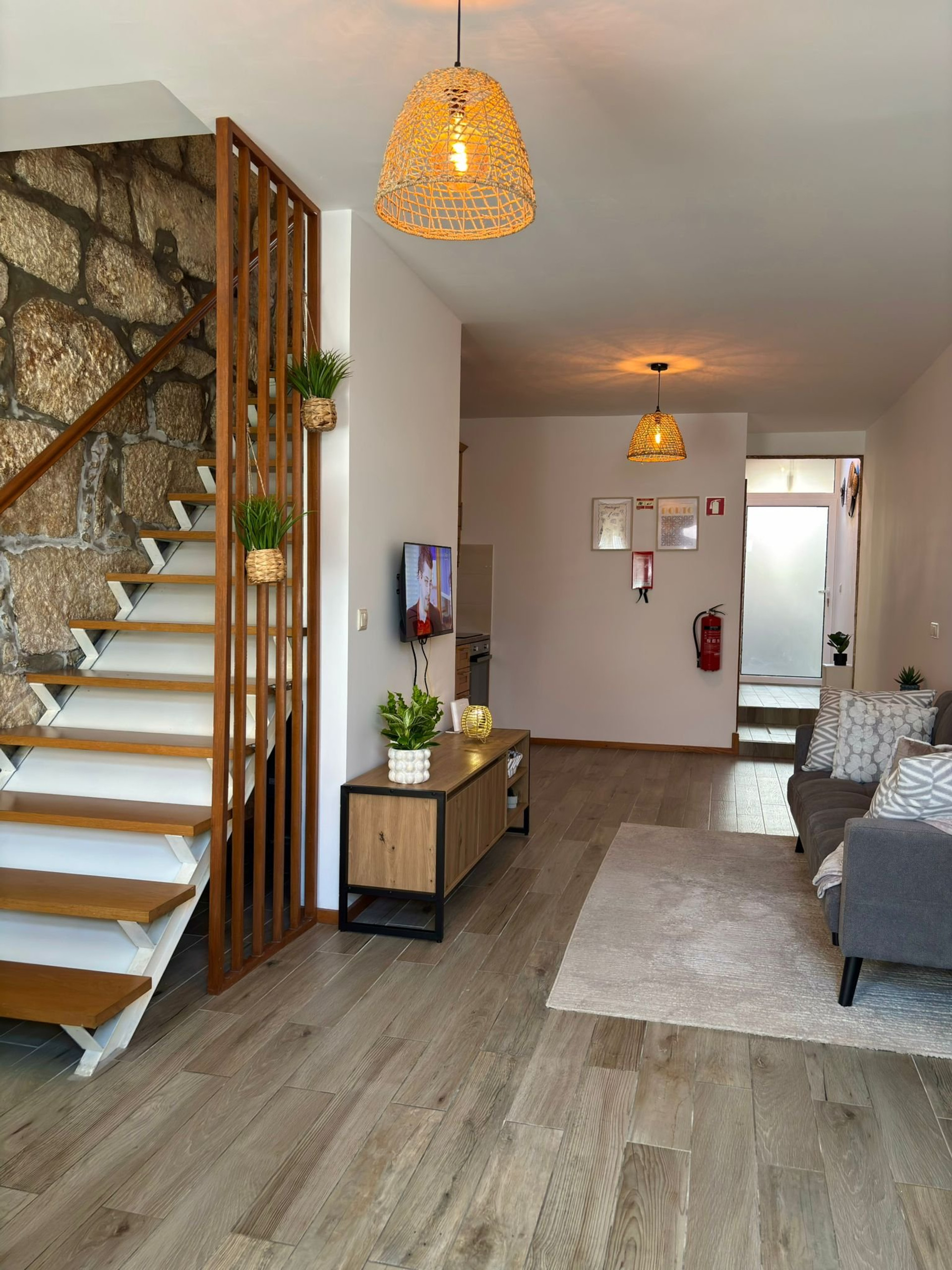 Living room with stone wall staircase