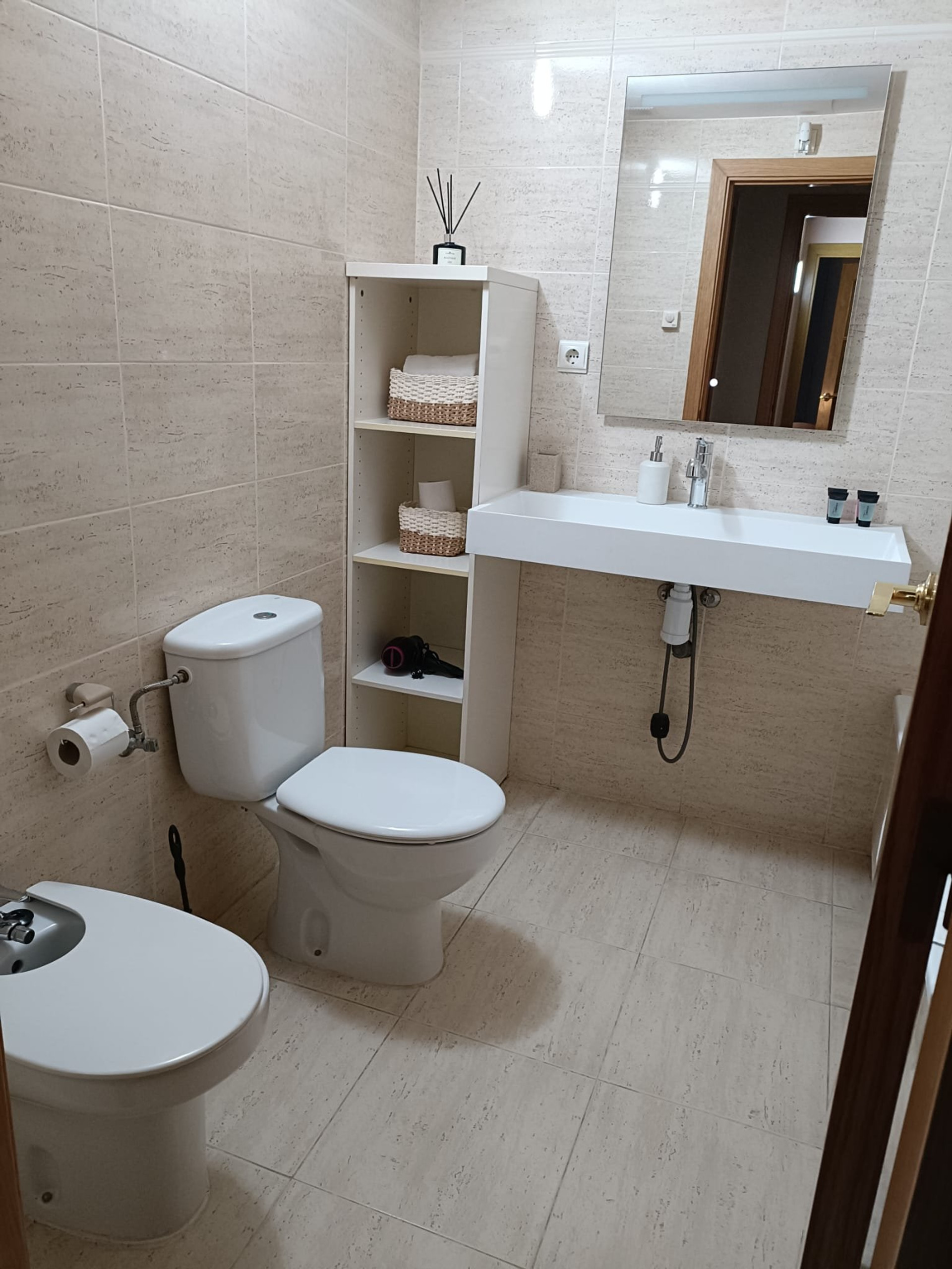 Bathroom with toilet and shelving