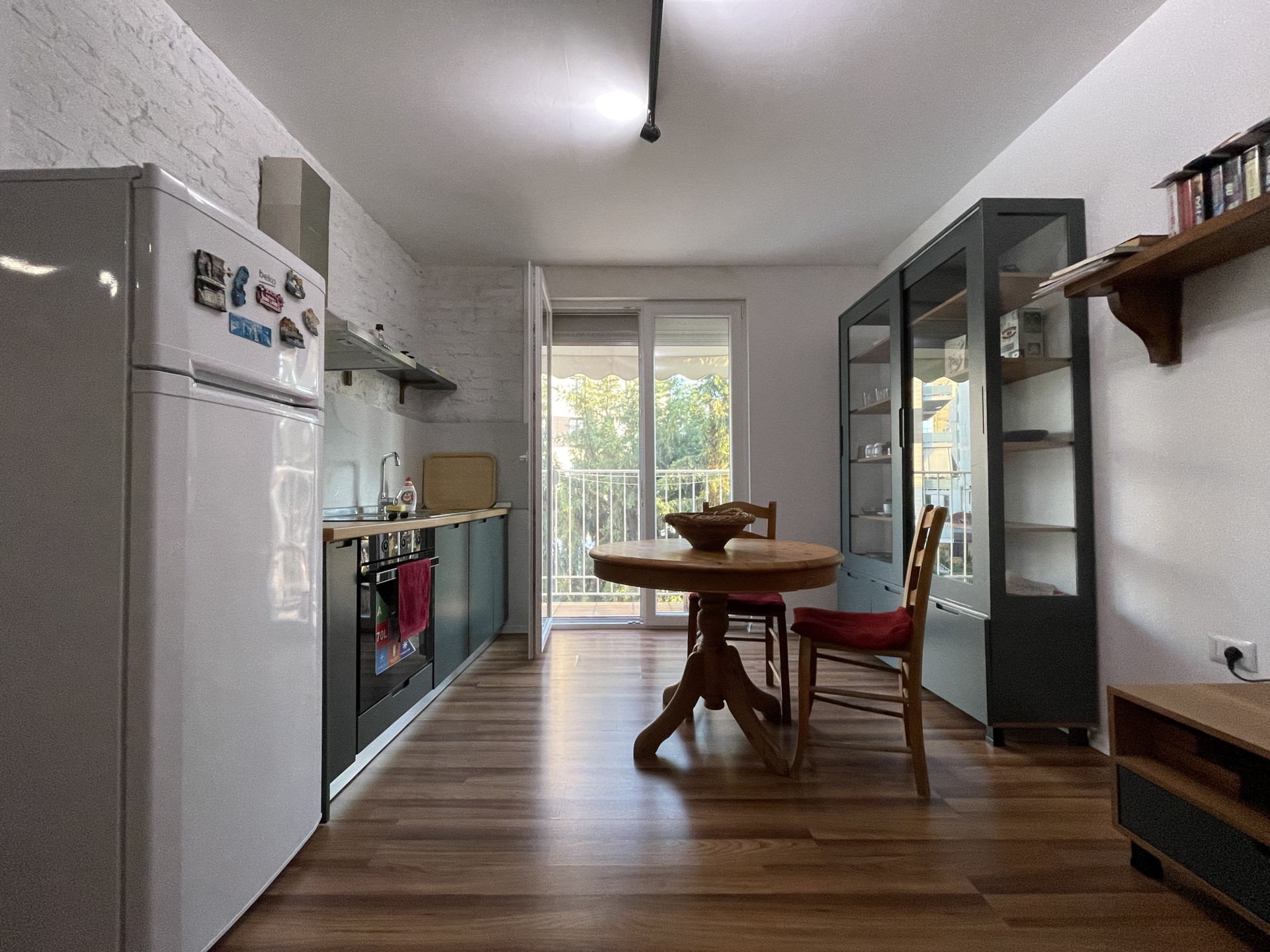 Kitchen and dining with balcony door
