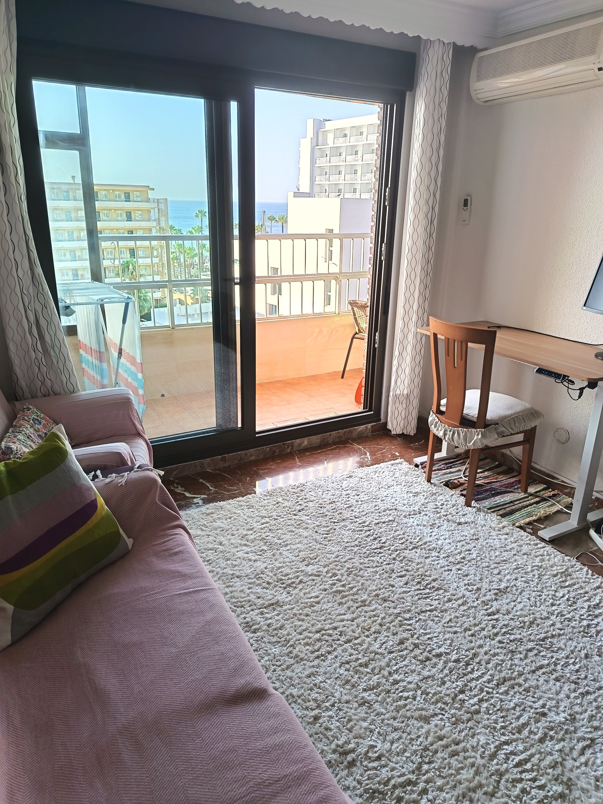 Living room with balcony access and stand up desk