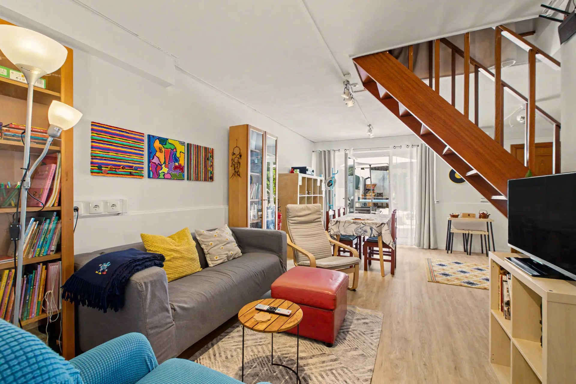 Living room with colorful artwork and TV