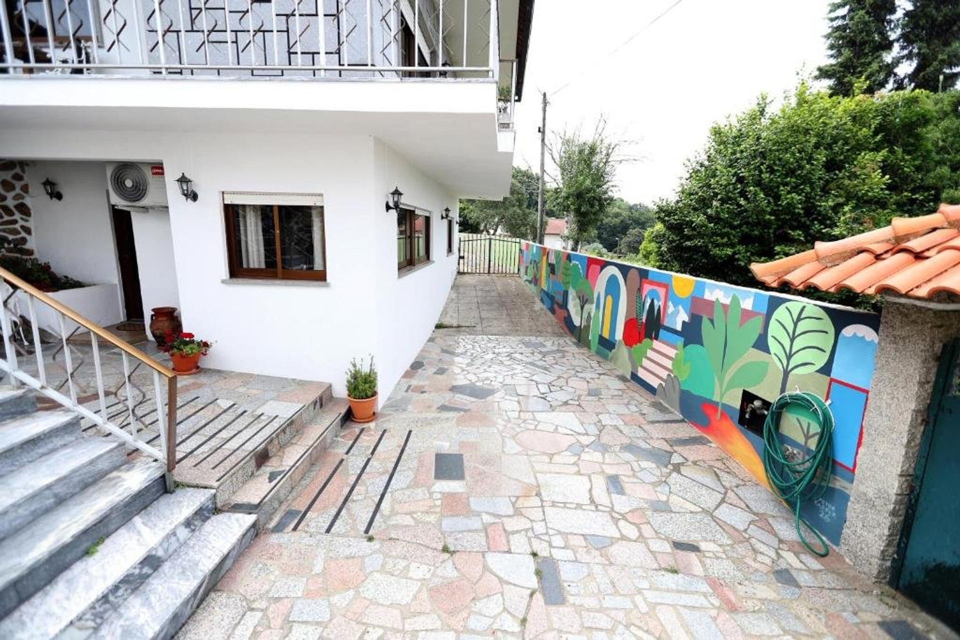 House exterior with courtyard and mural