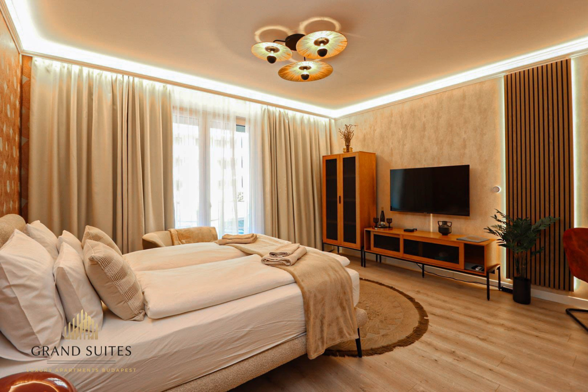 Bright bedroom with TV and wardrobe