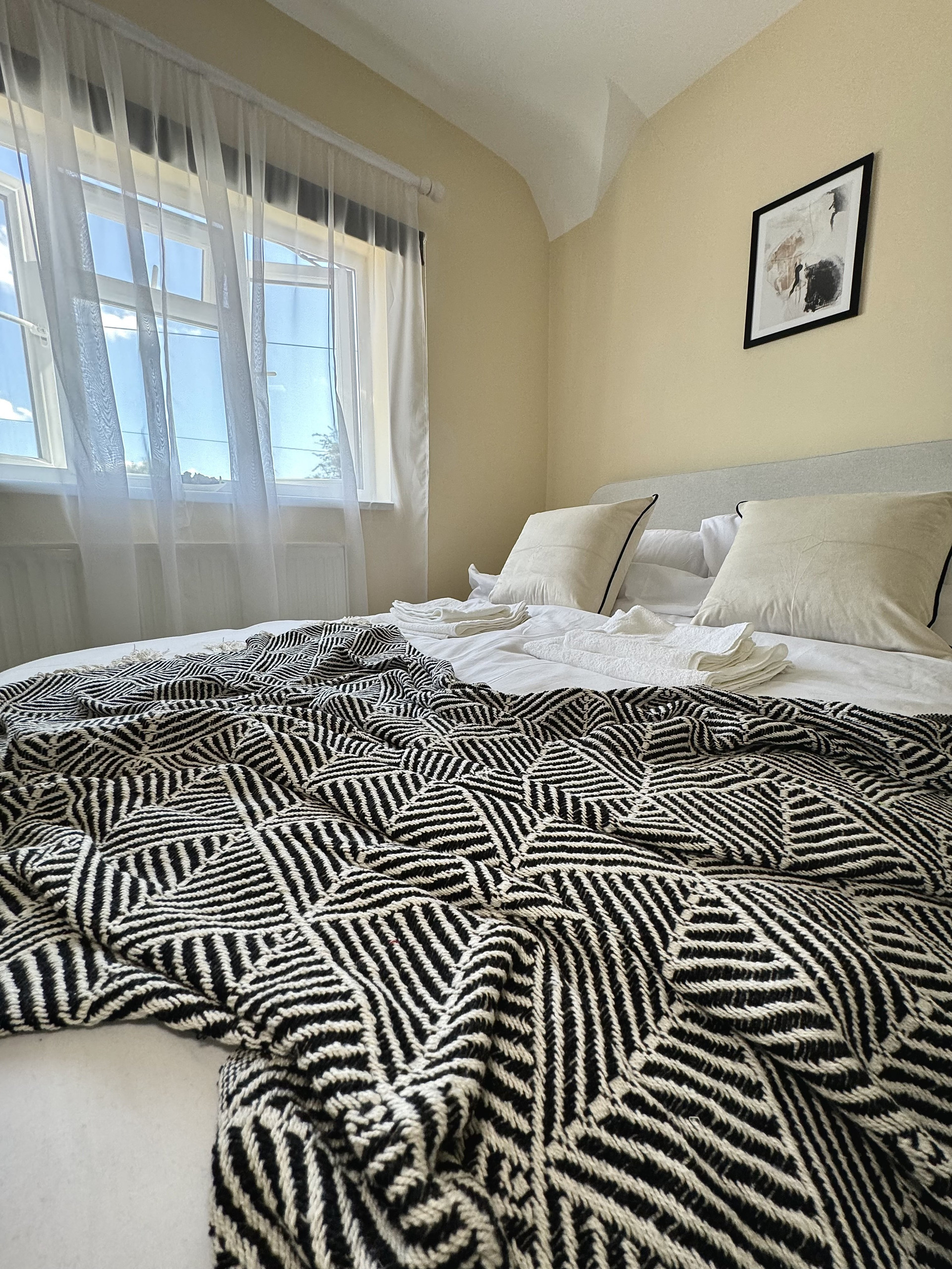 Bed with patterned throw blanket