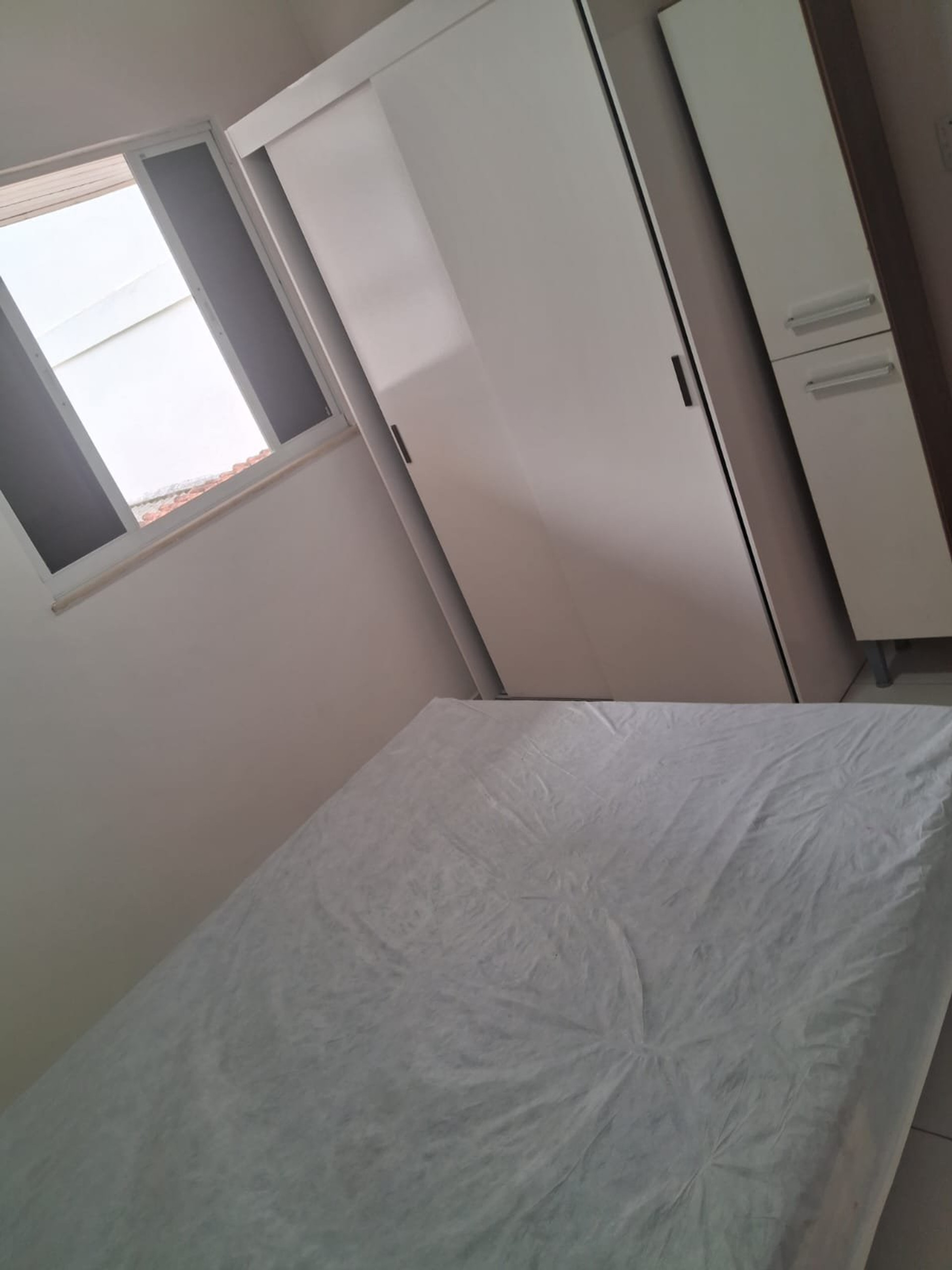 Bedroom with wardrobe and window