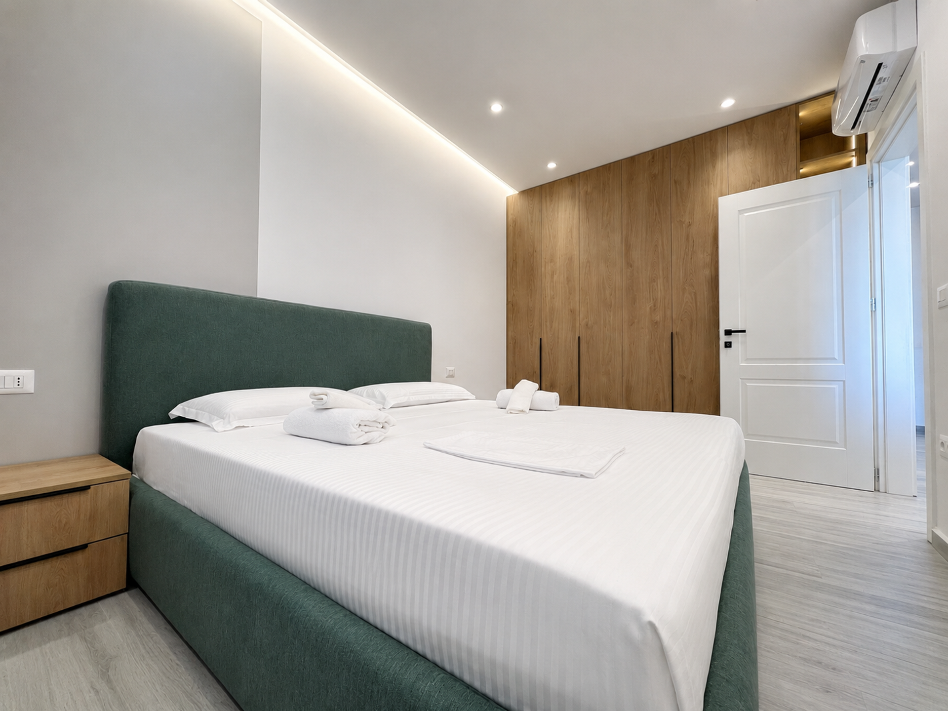 Master bedroom with green upholstered bed