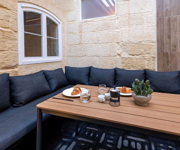 Outdoor lounge with breakfast setup