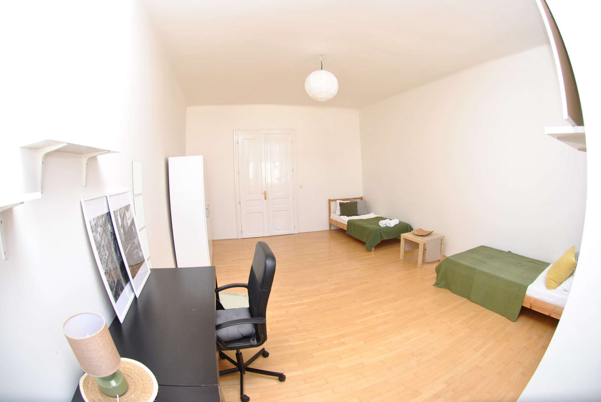 Spacious bedroom with two beds desk