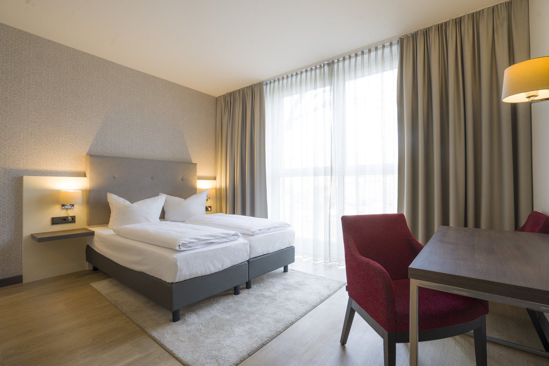Spacious bedroom with red chairs