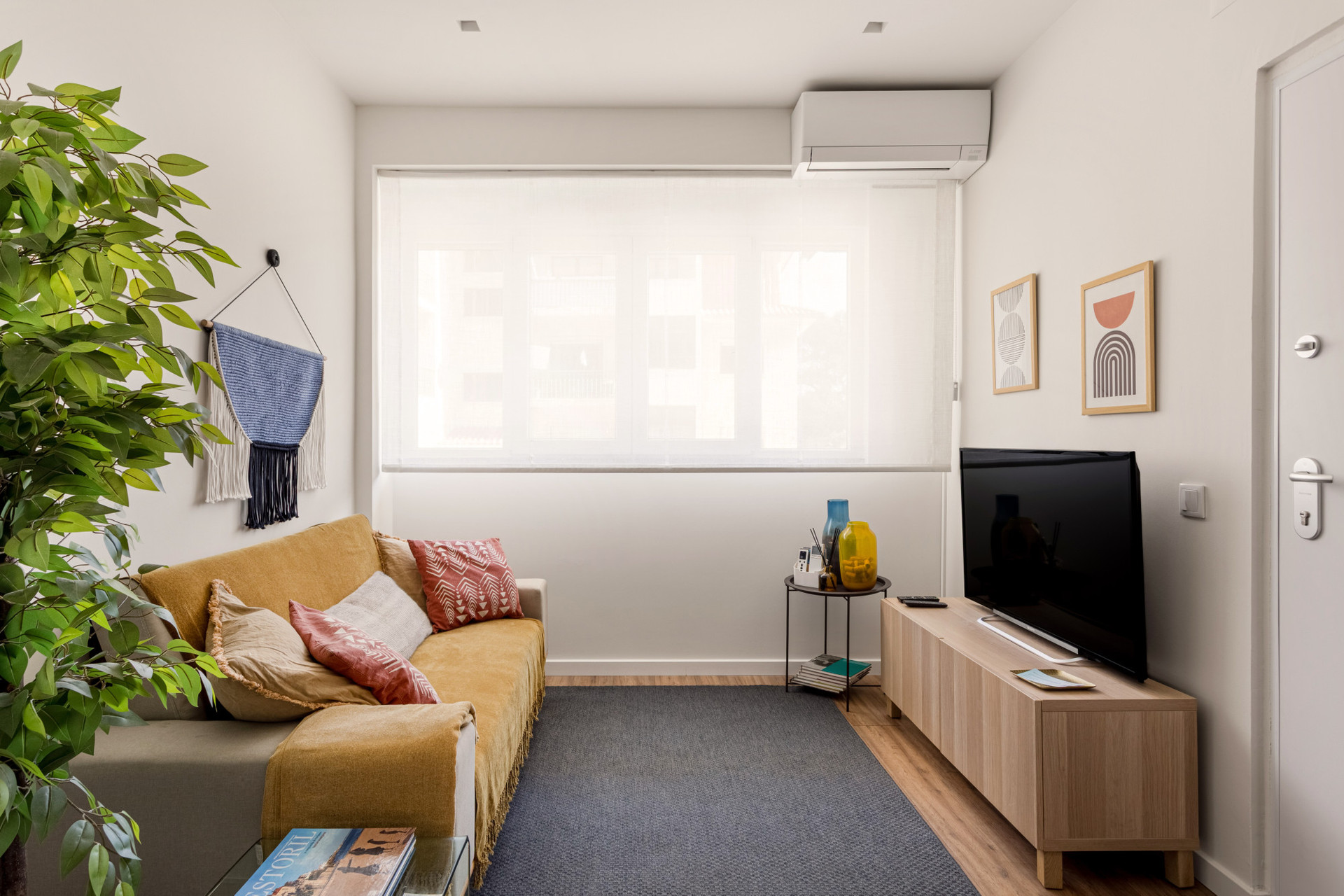 Living room with AC and TV.