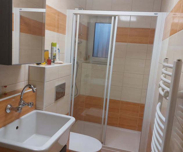Bathroom with shower and heated towel rail