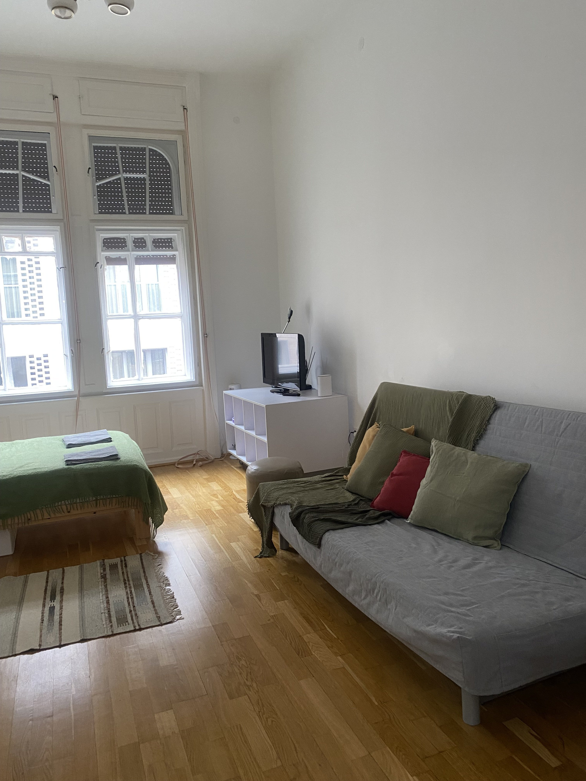 Spacious room with sofa and bed