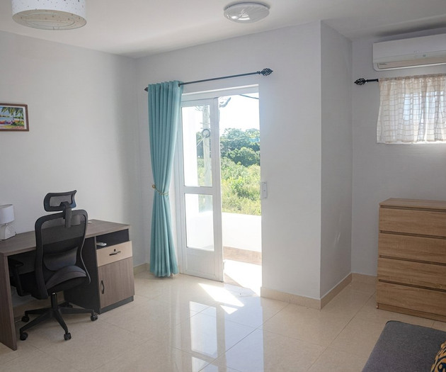 Bedroom with desk and balcony