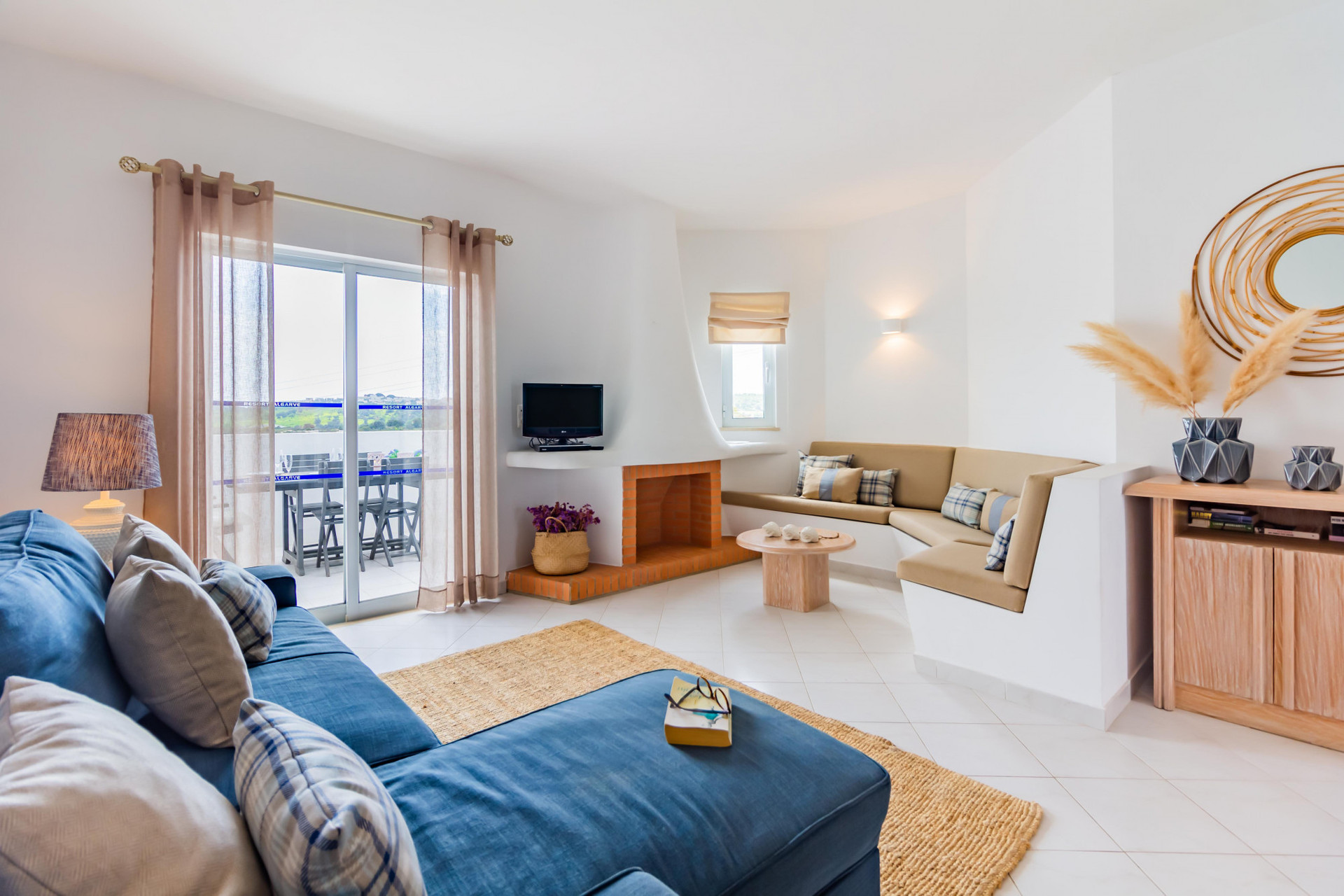 Living Room with Flat-Screen TV, Sofa and Balcony