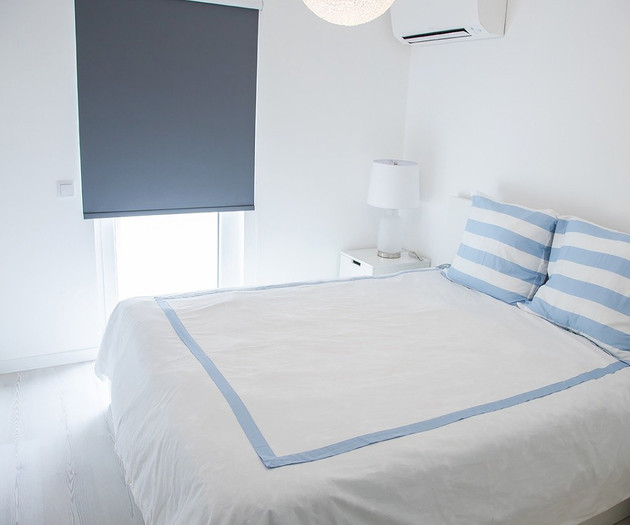Second bedroom with striped pillows