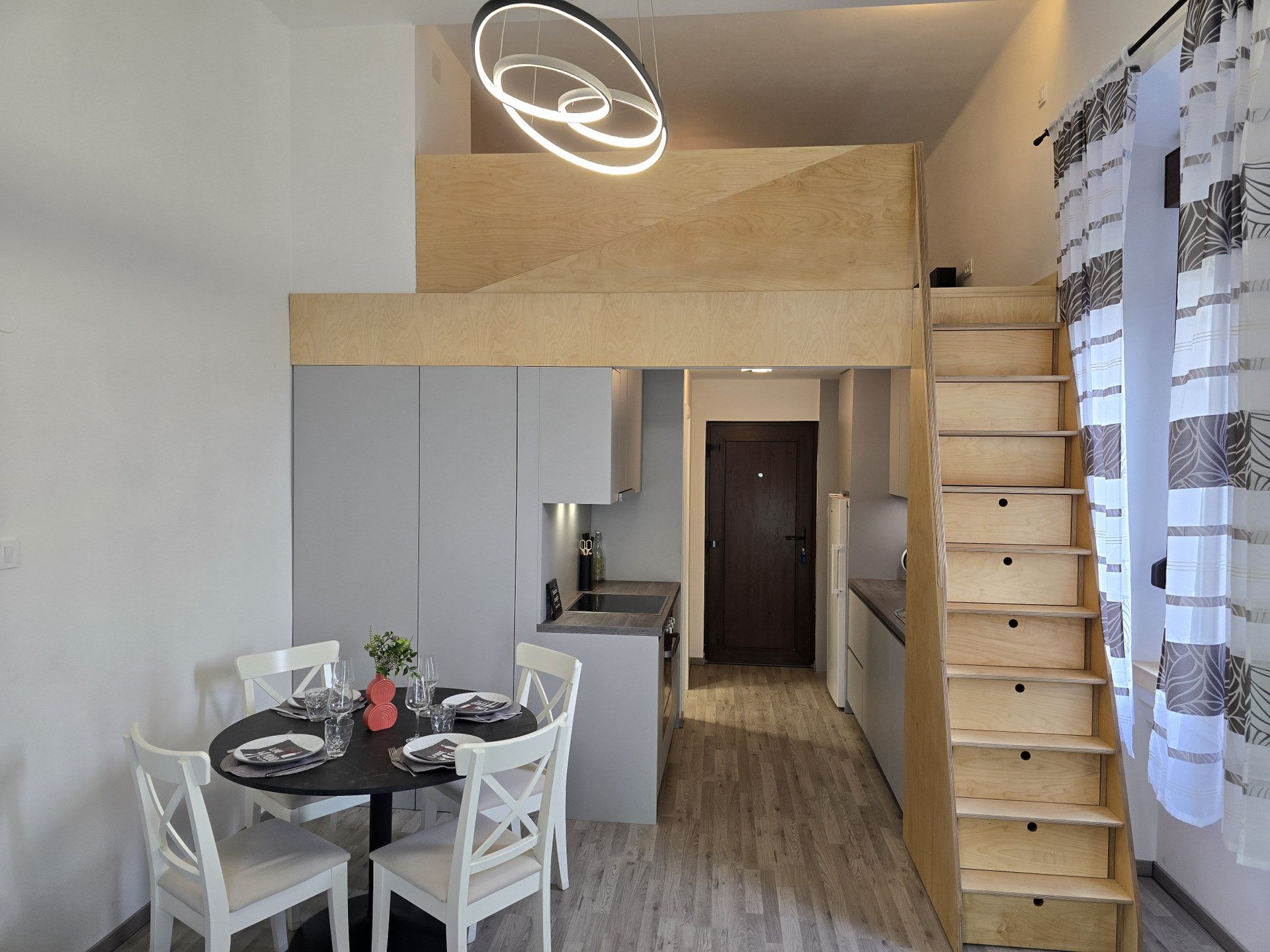 Open living area with loft stairs