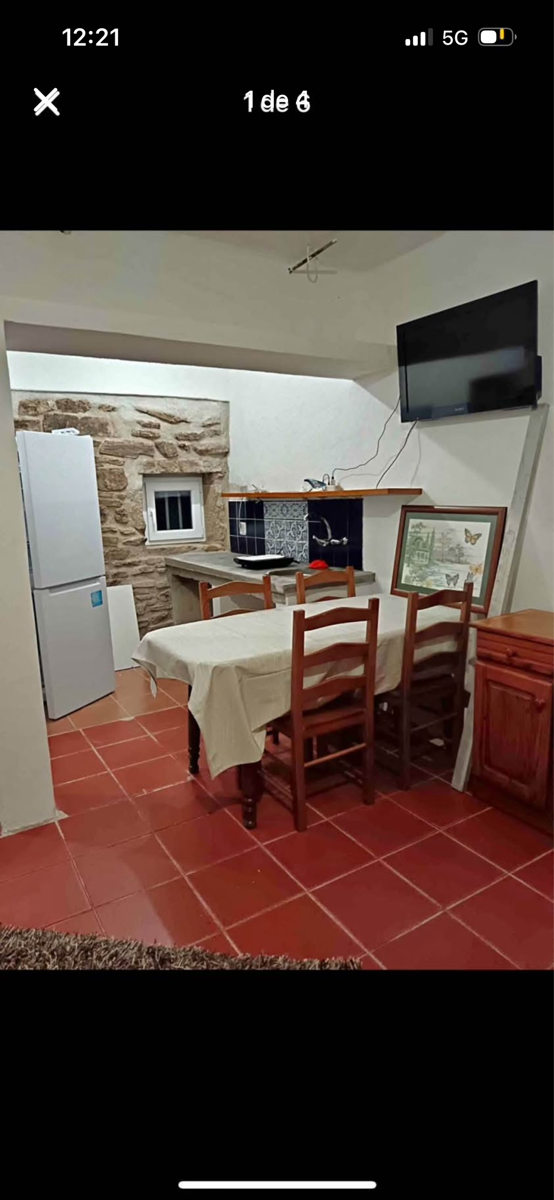 Dining area with kitchen and stone wall