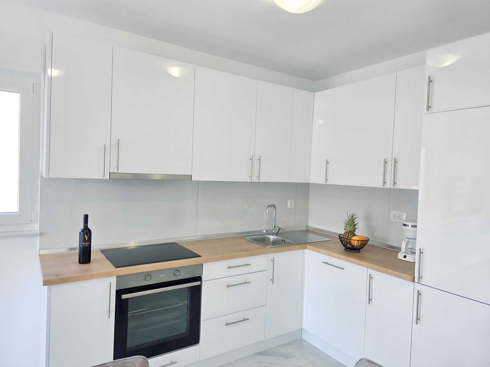 Modern white kitchen with wooden counters
