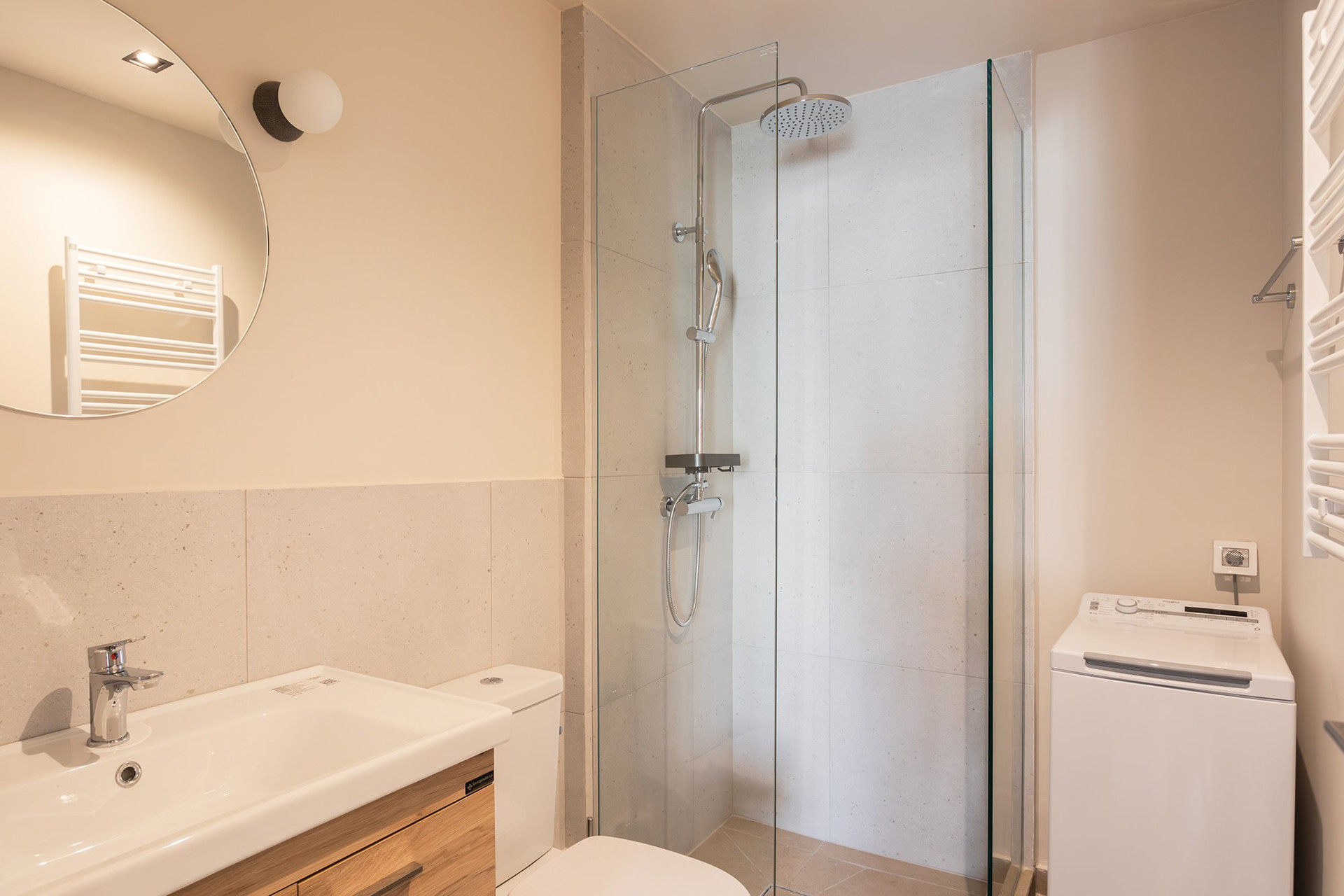 Bathroom with shower and washing machine