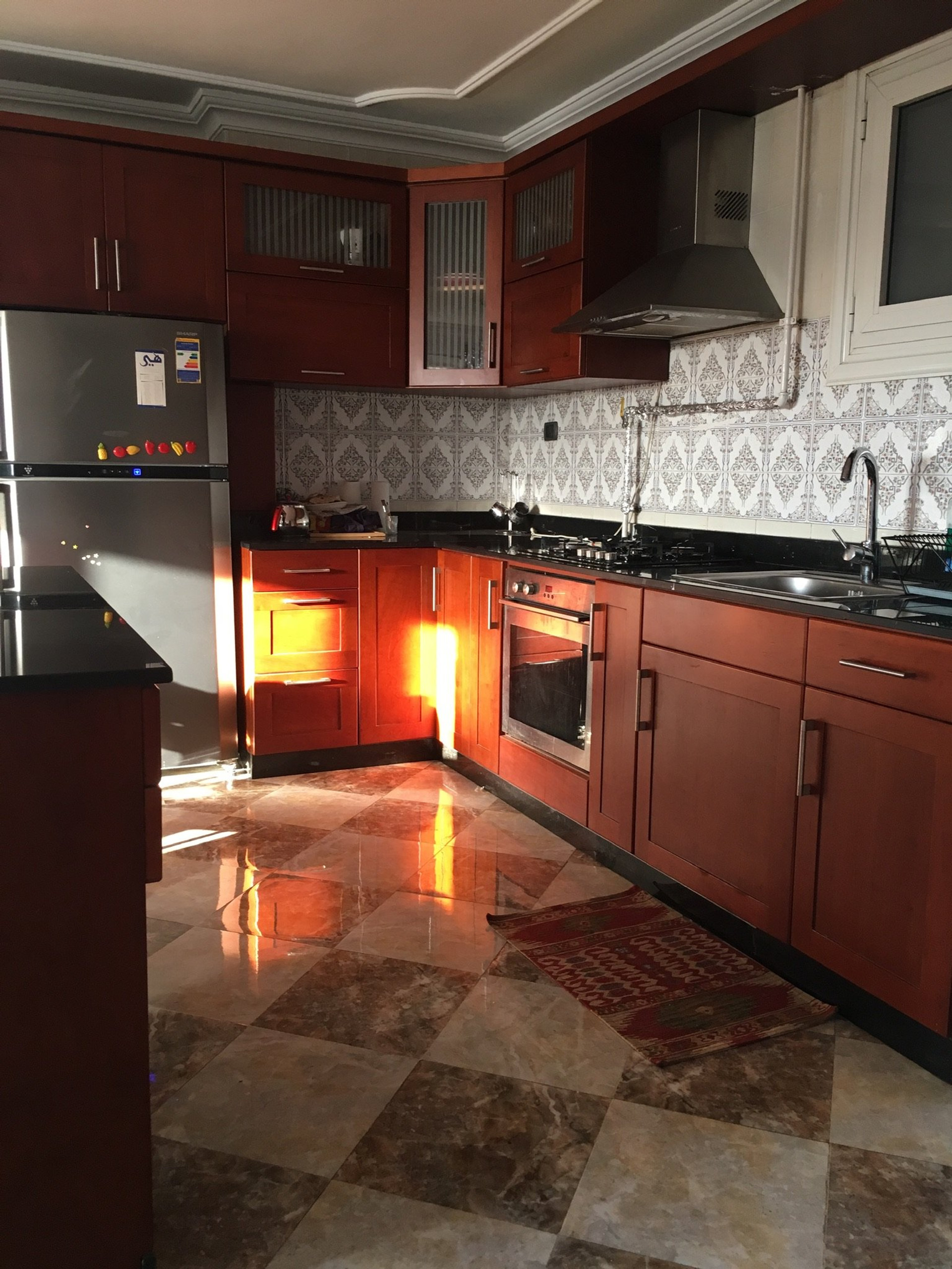 Spacious kitchen with dark wood cabinets