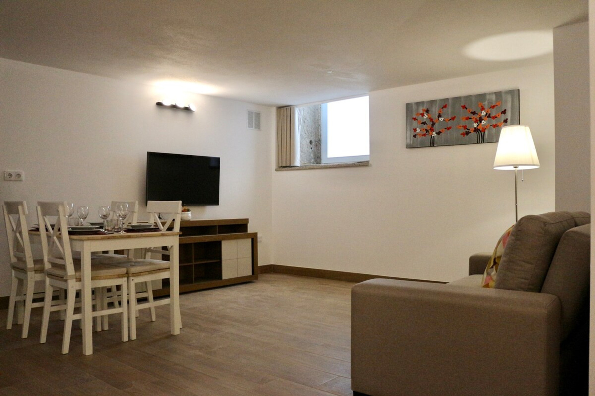 Dinning room and living room with a smart TV.