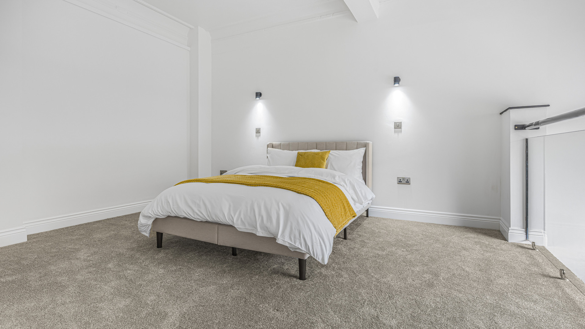 Bedroom double bed wall lights carpet