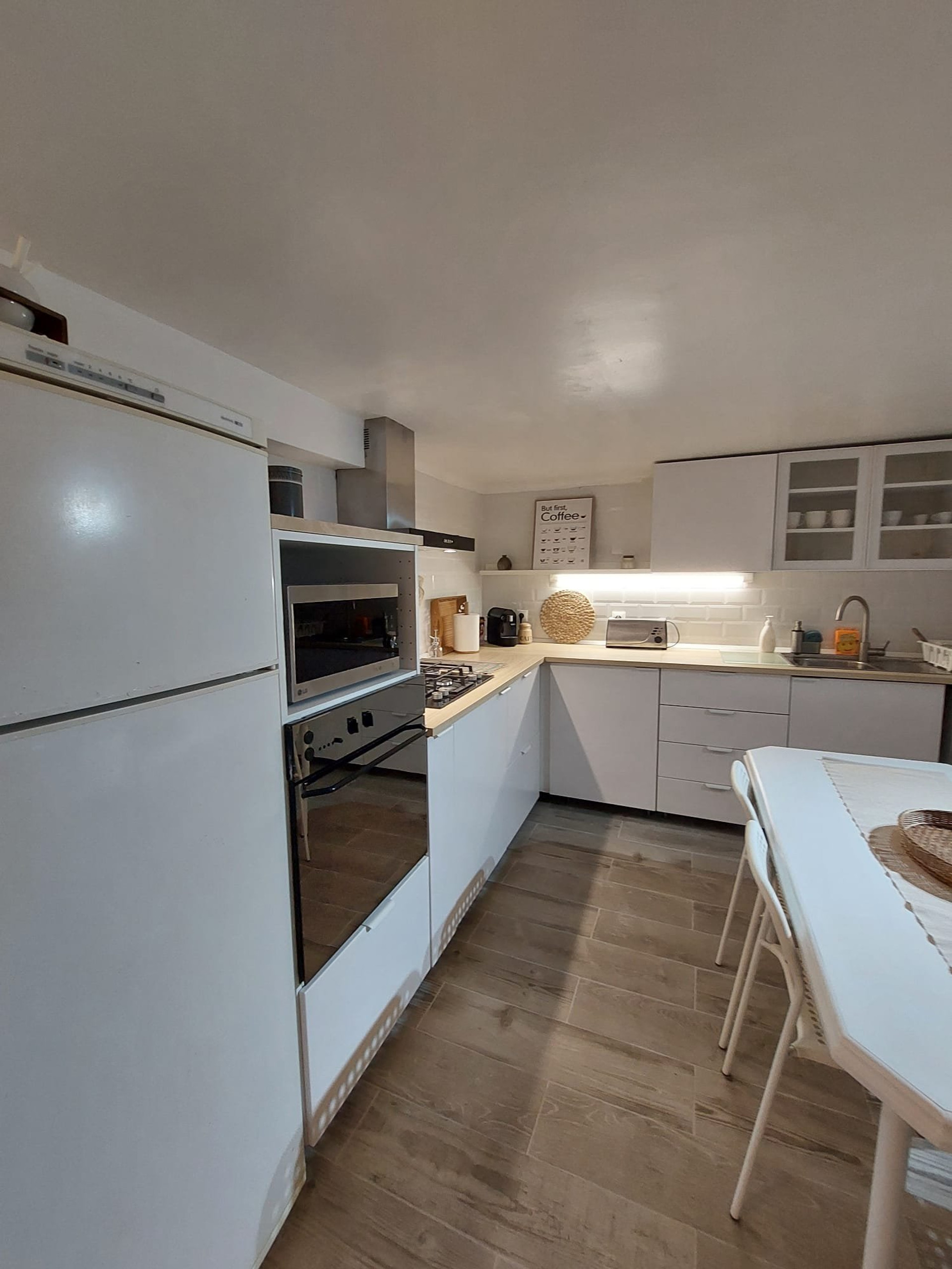 Kitchen with dining table and appliances