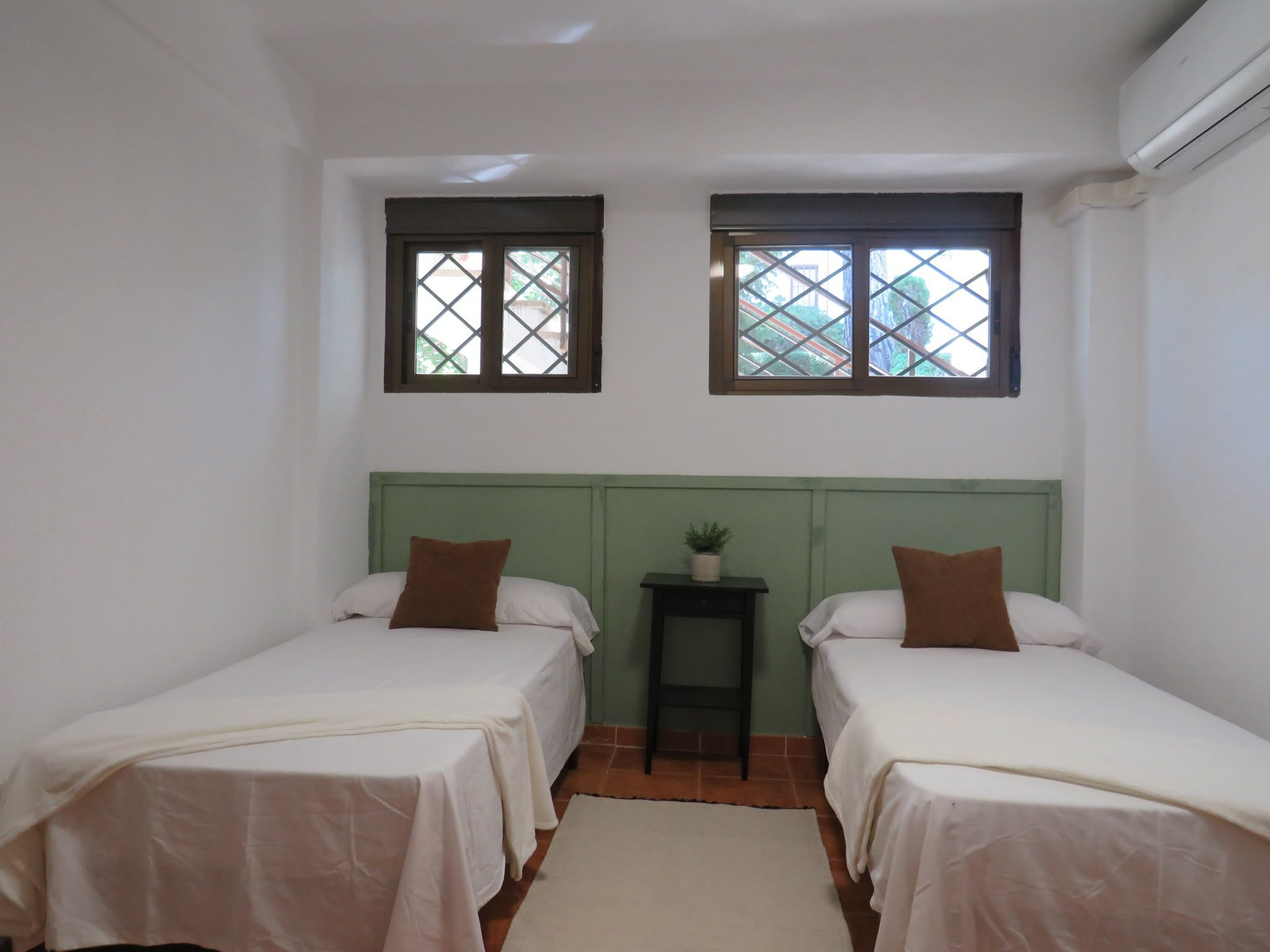 Twin bedroom green headboard two beds