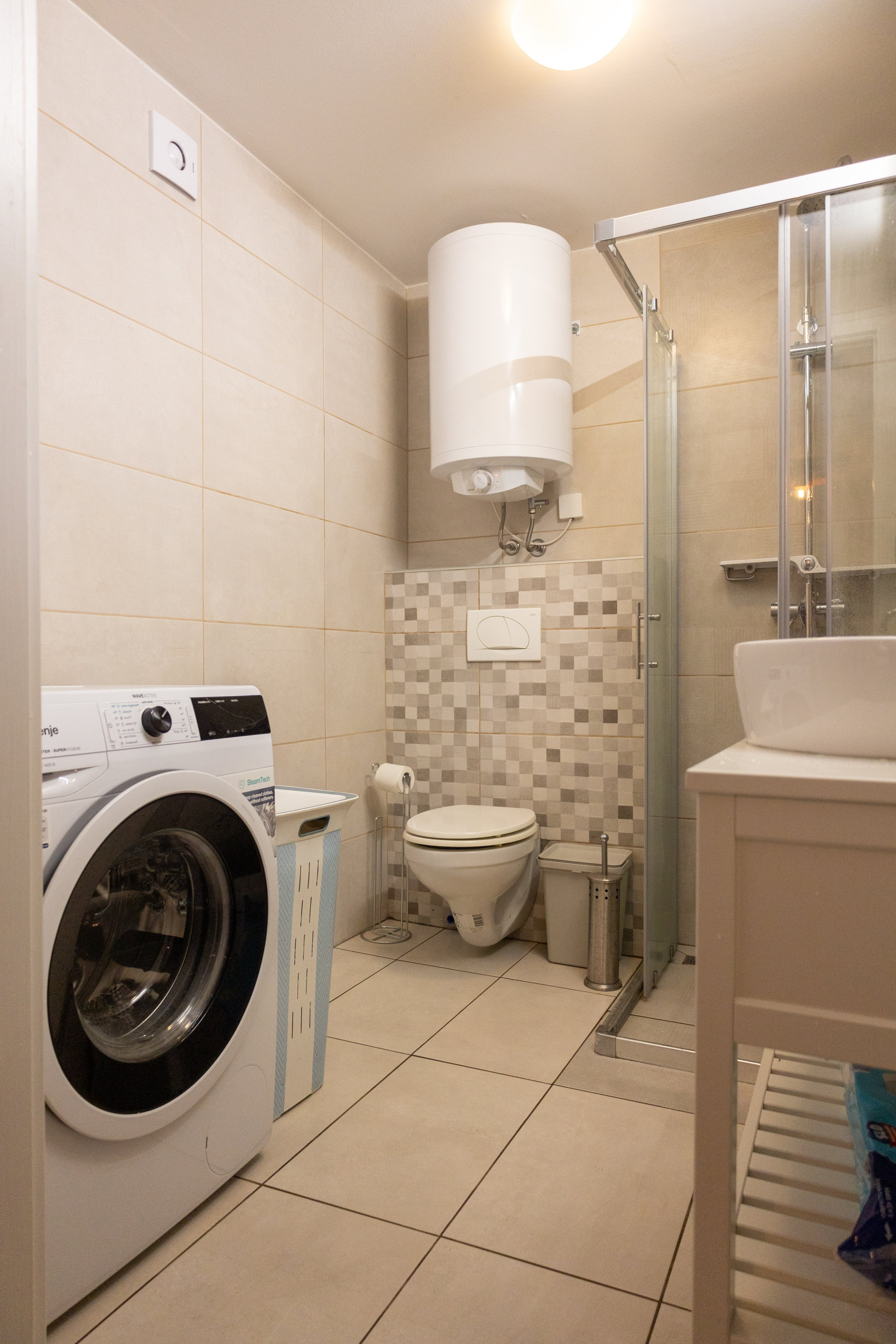 Bathroom with shower and washer