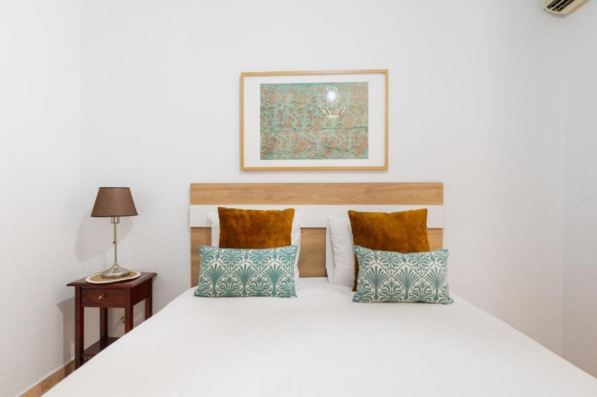 Bedroom with teal cushions