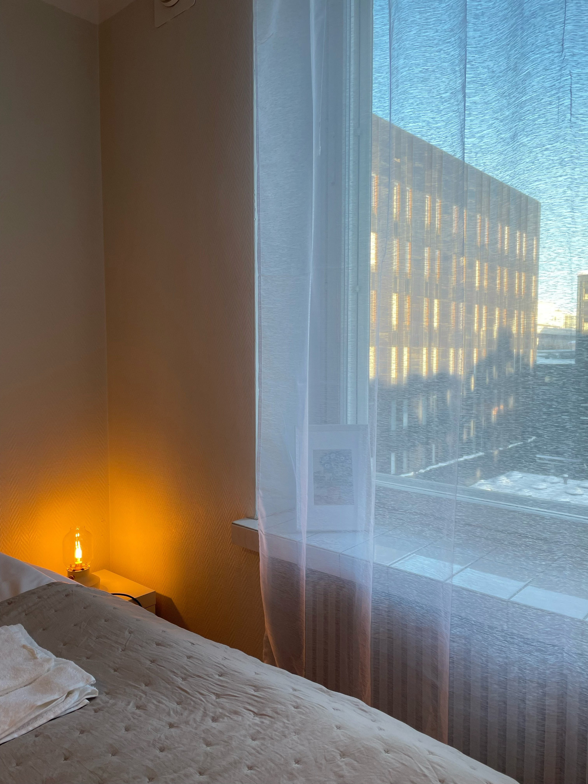 Bedroom window with sheer curtains