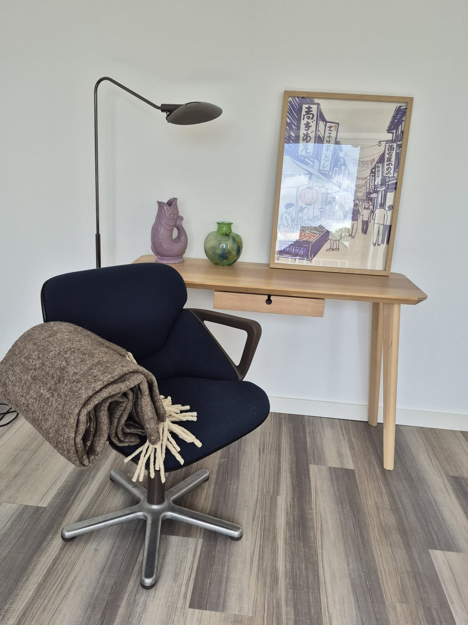 Desk corner with chair and artwork