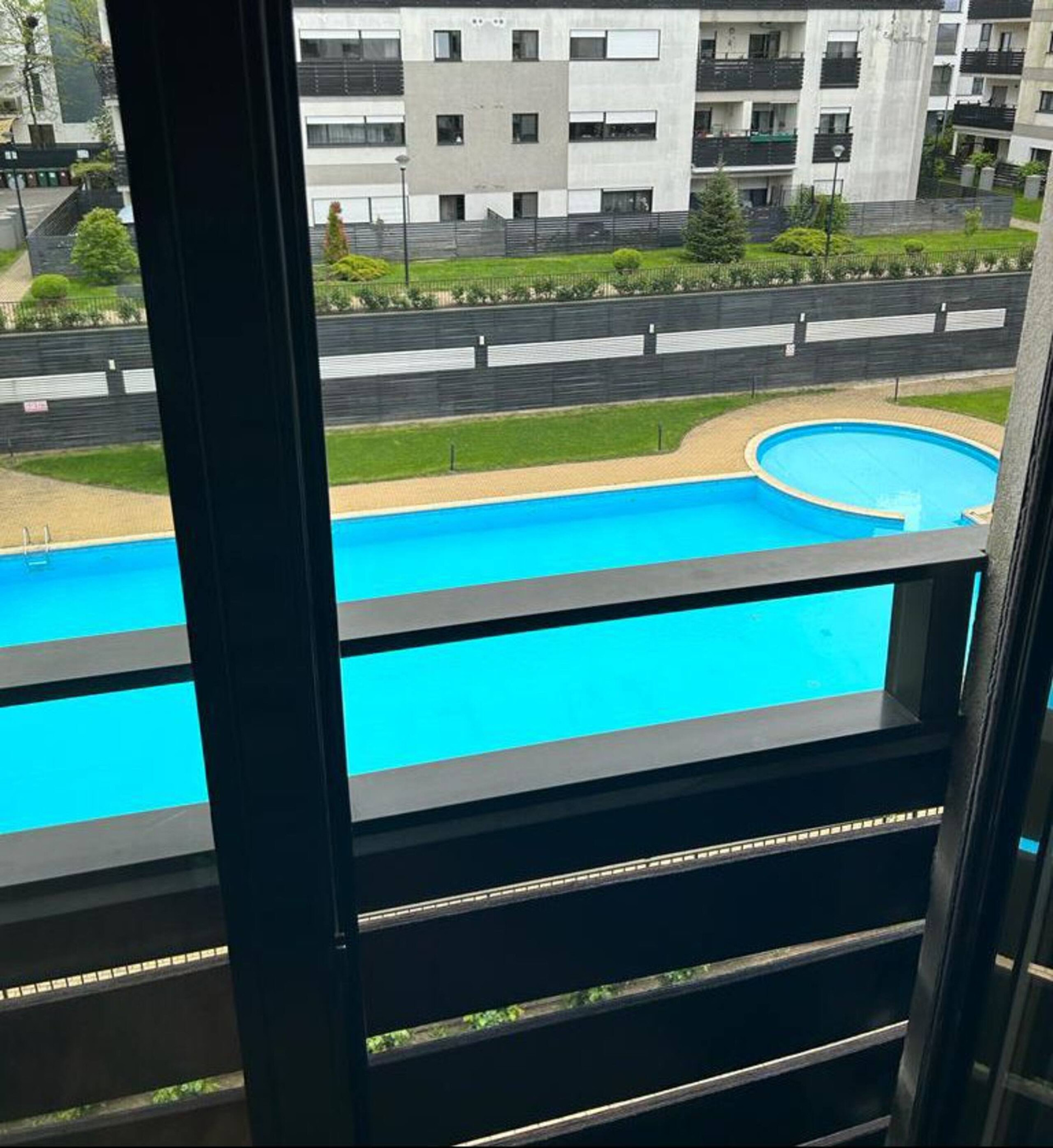 Balcony view of pool and building