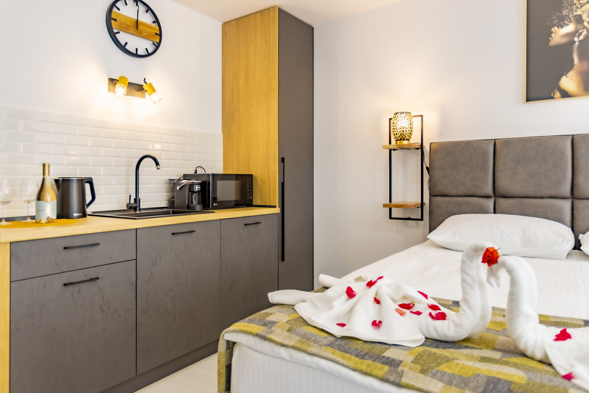 Kitchenette beside bed with towel swans